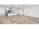 Open concept living room and kitchen with modern flooring at 12341 Filbert Rd, Weeki Wachee, FL 34614