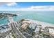 An aerial view showcasing the condo building's proximity to the beach, draw bridge, and ocean at 12924 Gulf Blvd # 503, St Petersburg, FL 33708