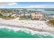 An aerial view showcasing the condo building's proximity to the beach, restaurants, and ocean at 12924 Gulf Blvd # 503, Madeira Beach, FL 33708