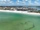 An aerial view showcasing the condo building's proximity to the beach, restaurants, and ocean at 12924 Gulf Blvd # 503, Madeira Beach, FL 33708