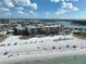 An aerial view showcasing the condo building's proximity to the beach, restaurants, and ocean at 12924 Gulf Blvd # 503, Madeira Beach, FL 33708