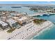 An aerial view showcasing the condo building's proximity to the beach, draw bridge, and restaurants at 12924 Gulf Blvd # 503, Madeira Beach, FL 33708