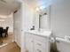 Bright bathroom features white vanity with a mirror and toilet with tile flooring at 12924 Gulf Blvd # 503, Madeira Beach, FL 33708