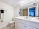 Well-lit bathroom featuring a white vanity and a shower with a gray shower curtain at 12924 Gulf Blvd # 503, Madeira Beach, FL 33708