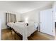 Bright bedroom showcases two beds with hard wood floors and natural light from the windows at 12924 Gulf Blvd # 503, Madeira Beach, FL 33708