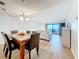 Contemporary dining area open to living room with balcony access and ocean view at 12924 Gulf Blvd # 503, Madeira Beach, FL 33708