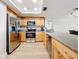 Modern kitchen with stainless steel appliances, granite countertops, and wood-look flooring at 12924 Gulf Blvd # 503, Madeira Beach, FL 33708