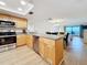 Well-lit kitchen featuring stainless steel appliances, granite countertops, and wood cabinets at 12924 Gulf Blvd # 503, Madeira Beach, FL 33708