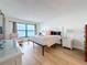 Bright bedroom featuring ocean view, a recliner, and a dresser at 12924 Gulf Blvd # 503, Madeira Beach, FL 33708