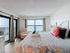 Cozy main bedroom featuring ocean view, balcony access, and stylish bedding and decor at 12924 Gulf Blvd # 503, Madeira Beach, FL 33708