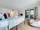 Inviting bedroom with ocean view, balcony access, recliner, and ensuite bathroom at 12924 Gulf Blvd # 503, Madeira Beach, FL 33708