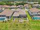 Overhead view of several homes featuring backyard pools, screened lanais, and outdoor seating areas at 13069 Paddock Wood Pl, Riverview, FL 33579