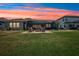 Landscaped backyard features a brick patio, screened-in porch, and fire pit, perfect for outdoor relaxation and entertaining at 13069 Paddock Wood Pl, Riverview, FL 33579