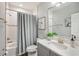 Well-lit bathroom featuring a vanity with marble countertop and bathtub with shower at 13069 Paddock Wood Pl, Riverview, FL 33579
