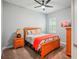 Cozy bedroom with a queen-size bed, ceiling fan, and warm color scheme at 13069 Paddock Wood Pl, Riverview, FL 33579