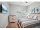 Bright bedroom featuring neutral paint, carpeted floors, and plantation shutters at 13069 Paddock Wood Pl, Riverview, FL 33579