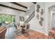 Dining room with wood beam accents and a modern table set near the staircase and sliding glass doors at 13069 Paddock Wood Pl, Riverview, FL 33579
