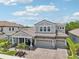 Beautiful two-story home with a brick driveway, manicured landscaping, three-car garage and covered front porch at 13069 Paddock Wood Pl, Riverview, FL 33579