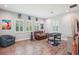 Inviting game room boasts tile flooring, a comfortable leather sofa, and foosball table at 13069 Paddock Wood Pl, Riverview, FL 33579