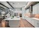 Modern kitchen featuring a center island, stainless steel appliances, and sleek white cabinetry at 13069 Paddock Wood Pl, Riverview, FL 33579