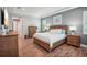 Comfortable main bedroom with wood furniture, tile floors, and a tray ceiling at 13069 Paddock Wood Pl, Riverview, FL 33579