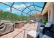 Covered patio with brick flooring, stylish seating, and peaceful backyard view at 13069 Paddock Wood Pl, Riverview, FL 33579