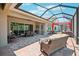 Spacious screened patio with dining area, seating, and serene outdoor space at 13069 Paddock Wood Pl, Riverview, FL 33579