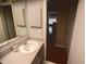 Well-lit bathroom with a neutral vanity, sink and view into the house at 1363 Overlea Dr, Dunedin, FL 34698