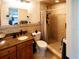 Bathroom with a tiled walk-in shower, and stylish granite vanity at 1363 Overlea Dr, Dunedin, FL 34698