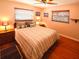 Cozy bedroom featuring hardwood floors, a comfortable bed, and lots of natural light at 1363 Overlea Dr, Dunedin, FL 34698