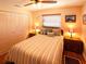 Comfortable bedroom features a queen bed, two nightstands, and a ceiling fan at 1363 Overlea Dr, Dunedin, FL 34698