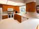Kitchen with ample cabinet space, a white countertop, and modern appliances at 1363 Overlea Dr, Dunedin, FL 34698