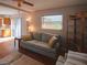 Comfortable living room with a plush sofa, stylish rug, and lots of natural light at 1363 Overlea Dr, Dunedin, FL 34698