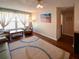Spacious living room featuring neutral walls and wood floors at 1363 Overlea Dr, Dunedin, FL 34698