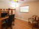 Home office with wood floors and a comfortable chair for working at home at 1363 Overlea Dr, Dunedin, FL 34698