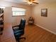 Cozy office space with wood-look floors, natural light, and comfortable executive chair at 1363 Overlea Dr, Dunedin, FL 34698