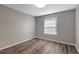 Neutral bedroom showcasing a window and hardwood flooring at 1400 Gandy N Blvd # 502, St Petersburg, FL 33702