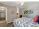 Cozy bedroom with a floral comforter, ceiling fan, and light gray walls at 1400 Gandy N Blvd # 502, St Petersburg, FL 33702