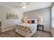 Bright bedroom with a floral comforter, ceiling fan, and light gray walls at 1400 Gandy N Blvd # 502, St Petersburg, FL 33702