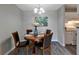 Cozy dining area with a round table set for four, featuring modern lighting and decor at 1400 Gandy N Blvd # 502, St Petersburg, FL 33702