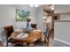 Well-lit dining area with wood floors, modern furnishings, and a view into the kitchen at 1400 Gandy N Blvd # 502, St Petersburg, FL 33702