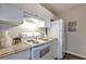 Charming kitchen features a white range oven, marbled countertop, and white cabinetry at 1400 Gandy N Blvd # 502, St Petersburg, FL 33702