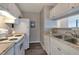 Efficient kitchen with white appliances, wood floors, and ample cabinet space at 1400 Gandy N Blvd # 502, St Petersburg, FL 33702