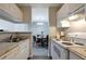 Open-concept kitchen and dining area featuring white cabinets, stainless steel sink, and range oven at 1400 Gandy N Blvd # 502, St Petersburg, FL 33702