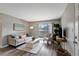 Bright living room with hardwood floors, neutral decor, and sliding glass doors to a balcony at 1400 Gandy N Blvd # 502, St Petersburg, FL 33702