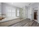 Bathroom featuring a soaking tub, glass enclosed shower, and shuttered windows providing natural light at 15702 Muirfield Dr, Odessa, FL 33556