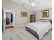 A cozy bedroom features neutral walls, vaulted ceiling, soft carpet, and a comfortable striped bed at 15702 Muirfield Dr, Odessa, FL 33556
