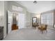 Neutral bedroom showcasing plush carpet, natural light and a view of the ensuite bathroom and walk-in closet at 15702 Muirfield Dr, Odessa, FL 33556