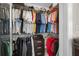 Walk-in closet with ample storage, multiple hanging rods, shelves, and organized clothing racks at 15702 Muirfield Dr, Odessa, FL 33556