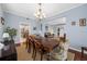 Charming dining area with hardwood floors, chandelier, and adjacent living spaces at 15702 Muirfield Dr, Odessa, FL 33556